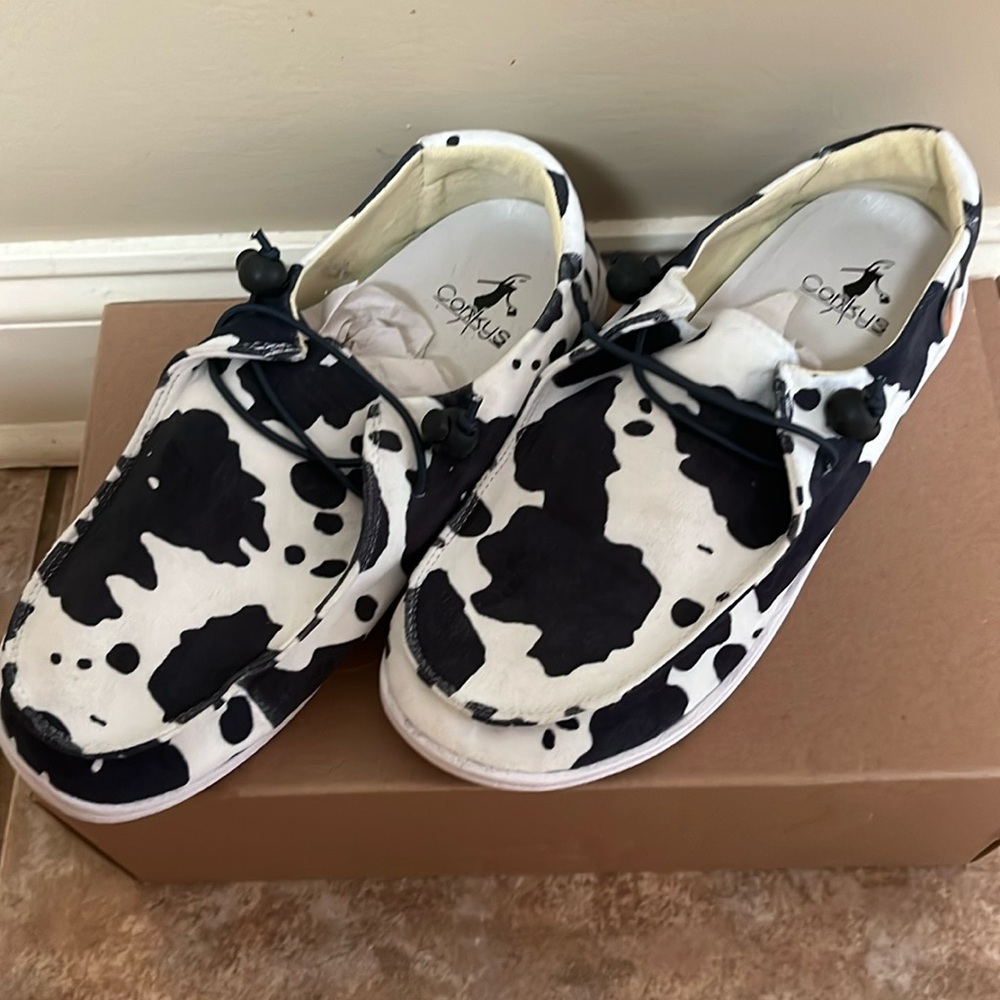New Corey’s kayaks slip on shoes in black and white cow print. Size 8